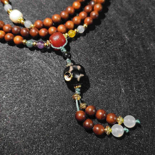 Close-up detail of the handmade mala beads. Shows the unique grain of the Lightning Struck Wood, smooth polished agate, and sparkling crystal, highlighting the quality and natural materials of this spiritual bracelet.