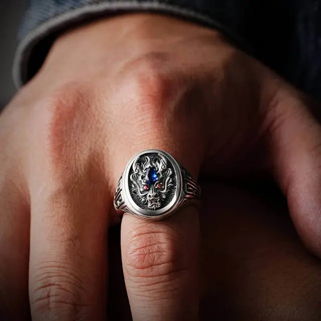 A man wearing our sculptural Copper Dragon Ring on hand. Shows the ring‘s bold size, comfortable fit, and how it looks as men’s jewelry.