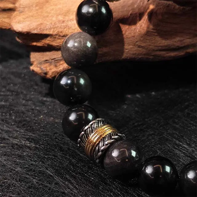 Close-up detail of the Zaki Lhamo Goddess of Wealth Bracelet, highlighting the natural silver obsidian beads and handcrafted Tibetan silver accents, perfect for those seeking finely made jewelry with spiritual significance.