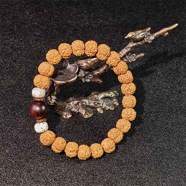 Zen-inspired natural Bodhi seed bracelet, a piece of earthy spiritual jewelry for grounding and protection, styled with dried plants and stones.
