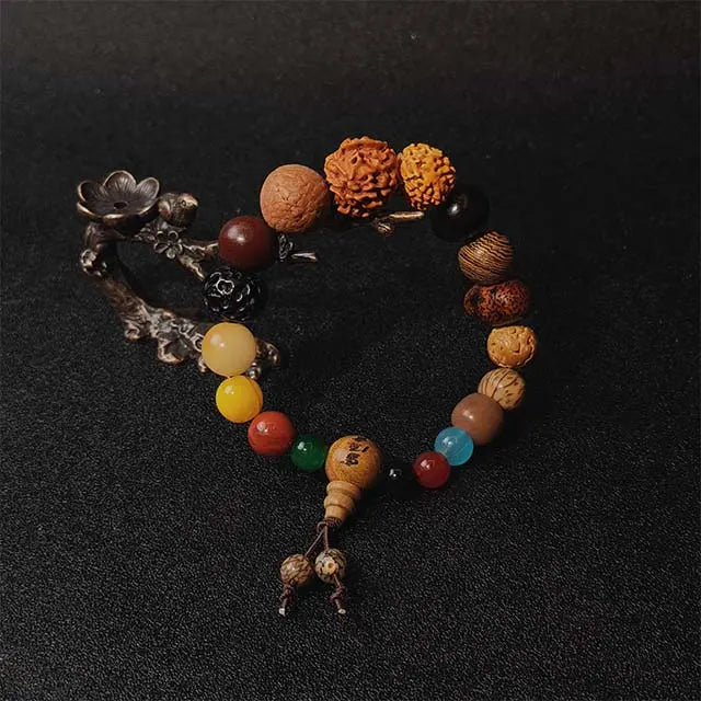 18-seed meditation bracelet featuring rich ebony wood and smooth agate beads, a mindful accessory for yoga and spiritual daily wear.