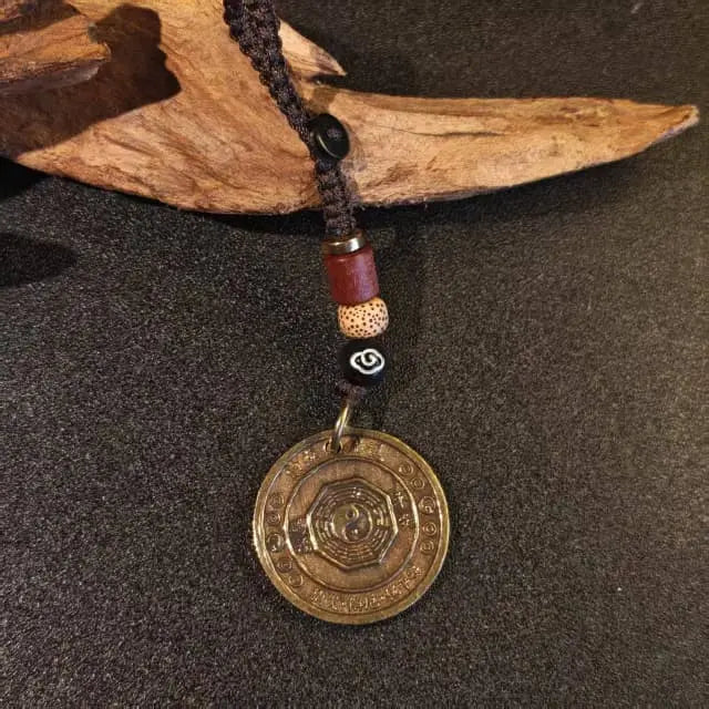 Brass Eight Diagram keychain, a unique feng shui accessory for good luck and protection.