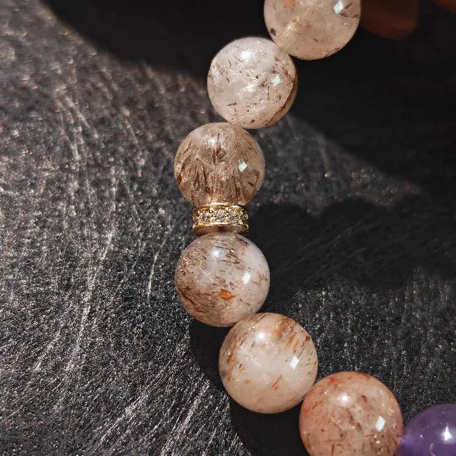 Natural gemstone bracelet made with Super Seven, amethyst, and moonstone beads, perfect for spiritual healing and daily wear to promote energetic harmony.