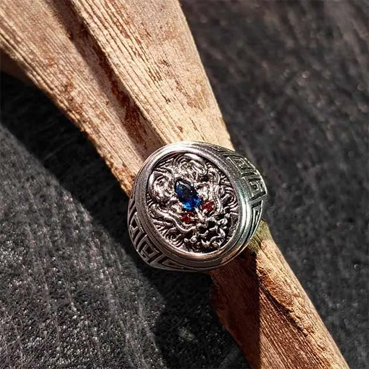 Extreme close-up of the Dragon Ring‘s texture and craftsmanship. Highlights the detailed scales, fierce expression, and warm copper patina of this handcrafted ring.
