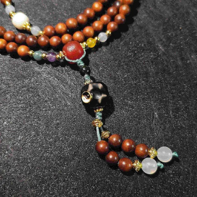 Close-up detail of the handmade mala beads.  Shows the unique grain of the Lightning Struck Wood, smooth polished agate, and sparkling crystal, highlighting the quality and natural materials of this spiritual bracelet.