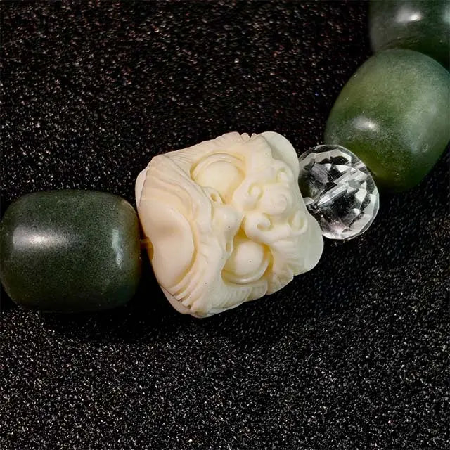 Handcrafted spiritual protection bracelet featuring green Bodhi seeds and a symbolic lion charm, promoting awareness and inner peace in daily wear.