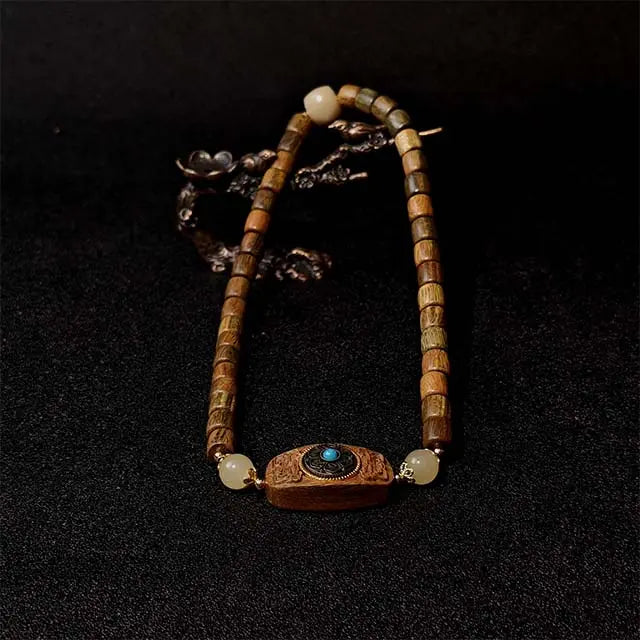 Handmade Green Sandalwood Double Strand Bracelet with a detailed wood inlay fortune disk charm, symbolizing luck and protection. A natural wooden jewelry piece for men and women.
