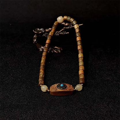 Handmade Green Sandalwood Double Strand Bracelet with a detailed wood inlay fortune disk charm, symbolizing luck and protection. A natural wooden jewelry piece for men and women.