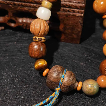 A close-up of our handmade Bodhi seed meditation bracelet, featuring smooth beads and a rustic gourd charm, perfect for daily wear.
