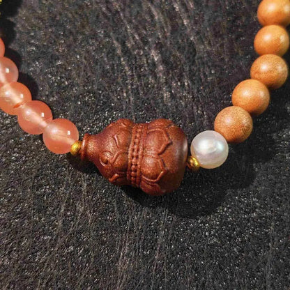 Artisanal meditation bracelet made with organic sandalwood and gourd beads. An ideal spiritual gift for mindful living, featuring adjustable ties and earthy tones for everyday wear.