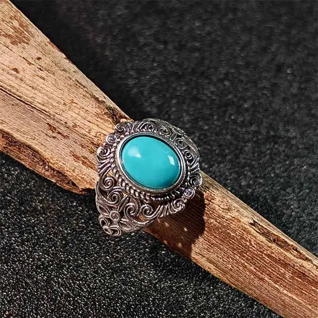 Close-up photo of a unique handmade Tibetan turquoise adjustable ring, showcasing the vibrant blue stone and intricate silver setting.