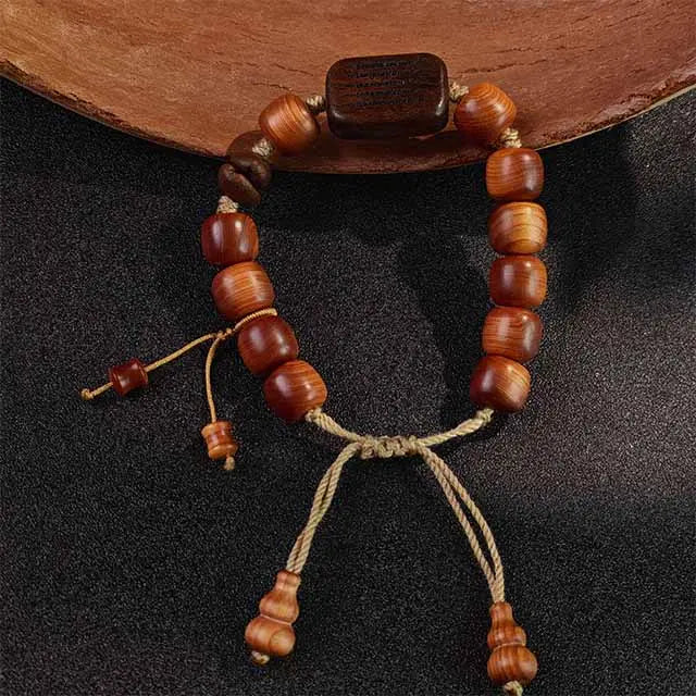  Handmade Himalayan-inspired mala bracelet for meditation, crafted from aromatic Thuja wood and rare Black Persimmon wood beads. A unique spiritual gift.
