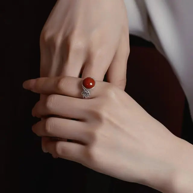A hand wearing the adjustable Himalayan Red Agate statement ring, showcasing the earthy Tibetan Carnelian stone against skin.Perfect for spiritual, or everyday bold look.