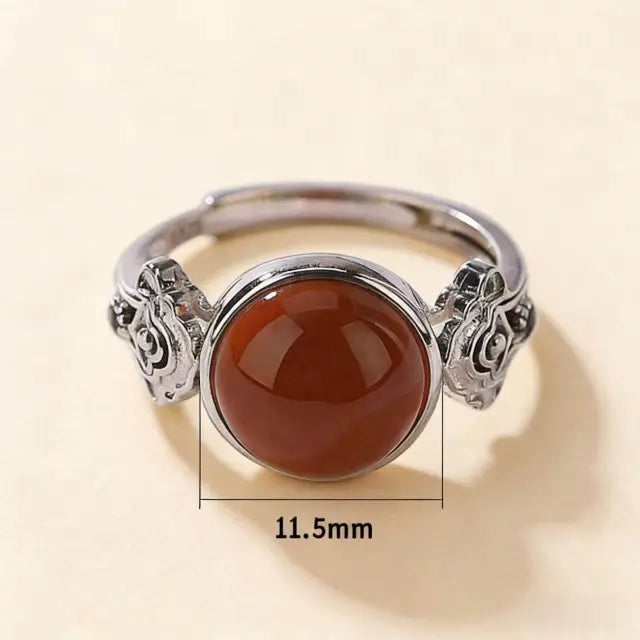 Flat lay overview of the Himalayan Red Agate adjustable statement ring.Features a prominent Tibetan Carnelian center stone,a sliding knot for size adjustment,and showcases the complete handcrafted bohemian design.