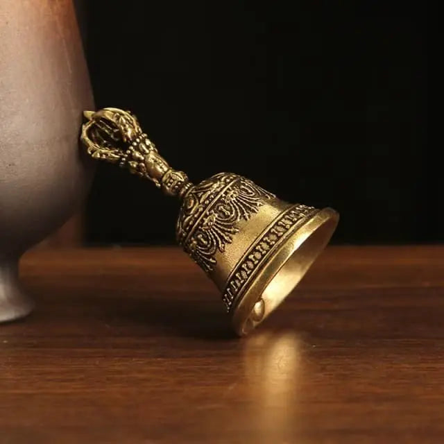A handcrafted Tibetan brass bell with a vajra handle, used for meditation, rituals, and spiritual decor