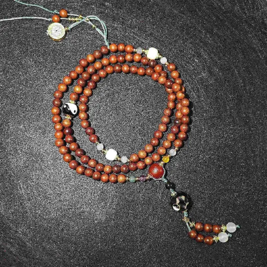A complete set of Lightning Struck Wood 108 Mala Bead Bracelet and Necklace, triple-wrapped for adjustable wear.  Features natural agate and clear crystal gemstones, spiritual meditation and mindful style.