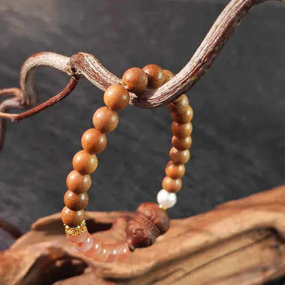 A minimalist spiritual bracelet crafted from aromatic sandalwood and gourd beads. This handmade meditation accessory promotes focus and calm during yoga or daily mindfulness rituals.