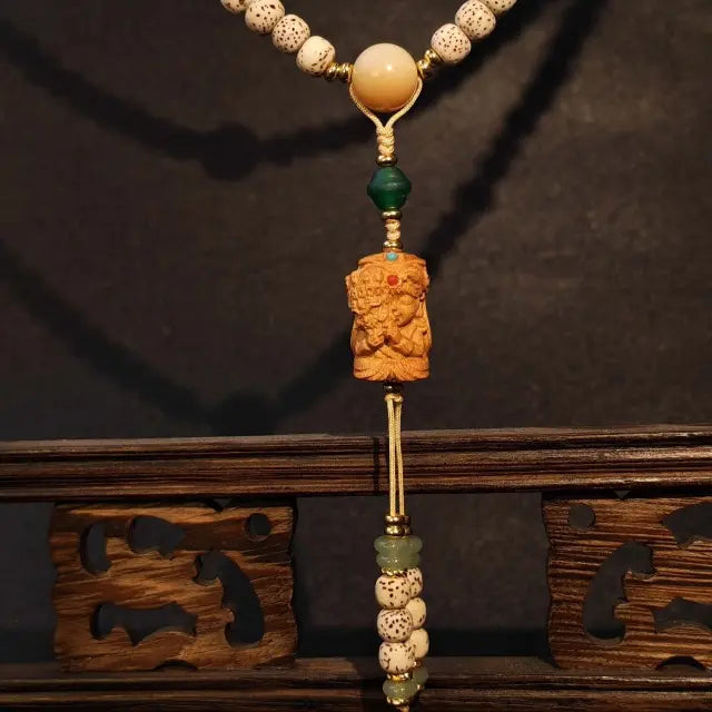 Close up detail of moon bodhi seed beads with agate sandalwood and pearl shell accents
