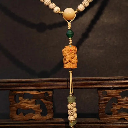 Close up detail of moon bodhi seed beads with agate sandalwood and pearl shell accents