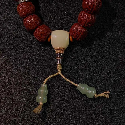 Bohemian-style unisex Bodhi bracelet with natural seeds and wooden beads, ideal for adding positive energy to casual or spiritual outfits.