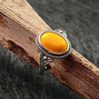 Close-up of a genuine Tibetan amber ring for men and women, showcasing the organic honey-gold color and unique inclusions of the fossilized resin.