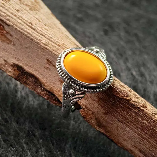 Close-up of a genuine Tibetan amber ring for men and women, showcasing the organic honey-gold color and unique inclusions of the fossilized resin.