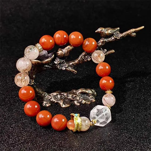A handcrafted Red Agate bracelet combined with Super Seven and White Crystal beads, designed as healing energy jewelry to promote balance and protection.