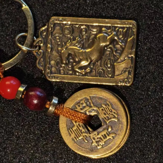 Close-up of handcrafted solid brass horse zodiac coin keychain with vintage artisan details