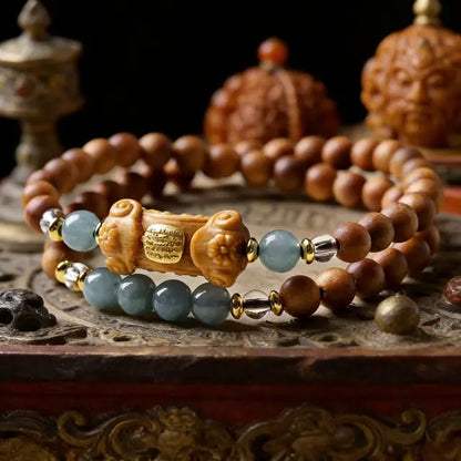 Tibetan-style spiritual bracelet with wood and jade beads displayed in a meditation setting with traditional ornaments and warm lighting
