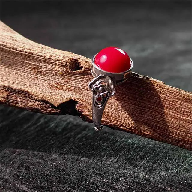Close-up of natural Tibetan Carnelian stone in handmade adjustable ring, showcasing raw texture and vibrant red-orange hues.