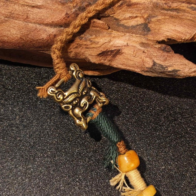 Close-up of Tibetan necklace vintage clasp and handcrafted braided details with wooden beads and ethnic design