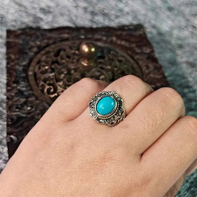 Lifestyle photo of the handmade adjustable turquoise ring being worn, showing its bohemian and spiritual style on a person’s hand.
