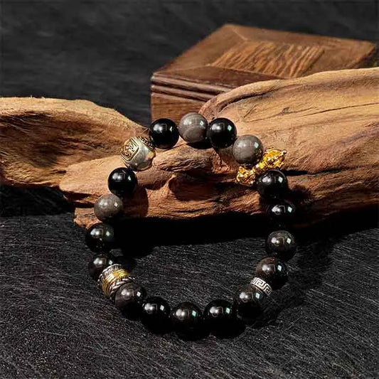 Front view of the handmade Zaki Lhamo Goddess of Wealth Bracelet, crafted from silver obsidian and Tibetan silver, showcasing its intricate design as a unique spiritual accessory for attracting wealth and positive energy.