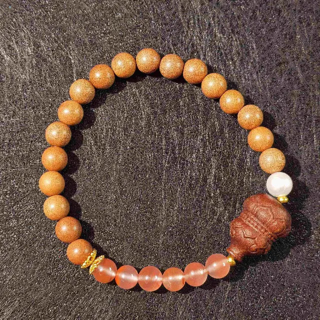 Handmade Zen sandalwood gourd bead bracelet on a natural wood surface, perfect for meditation and mindfulness practice. 