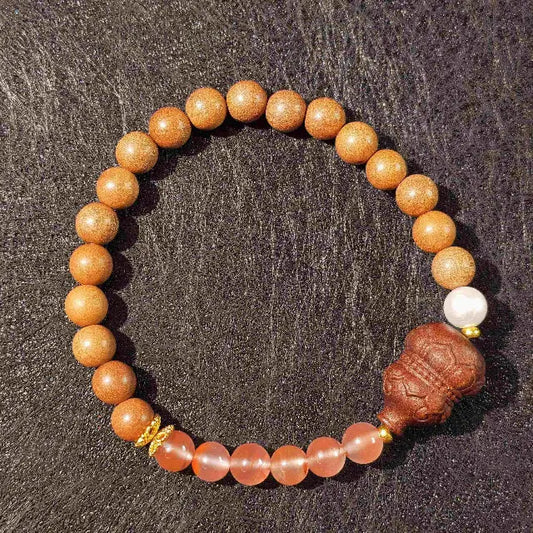 Handmade Zen sandalwood gourd bead bracelet on a natural wood surface, perfect for meditation and mindfulness practice. 